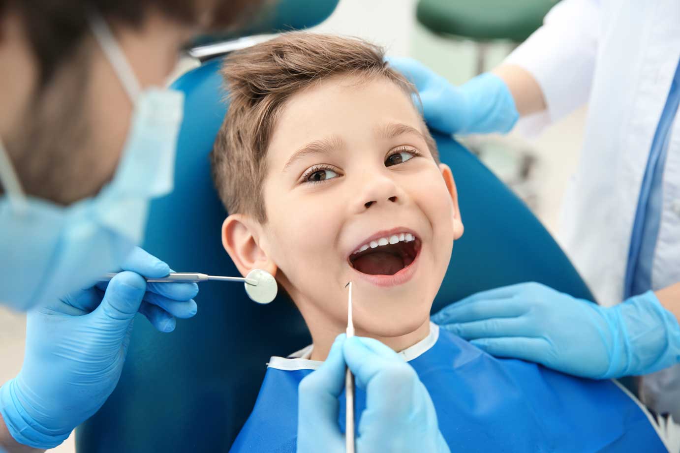 https://smilespanorthjersey.com/wp-content/uploads/Dentist-examining-little-boys-teeth-in-clinic.jpg